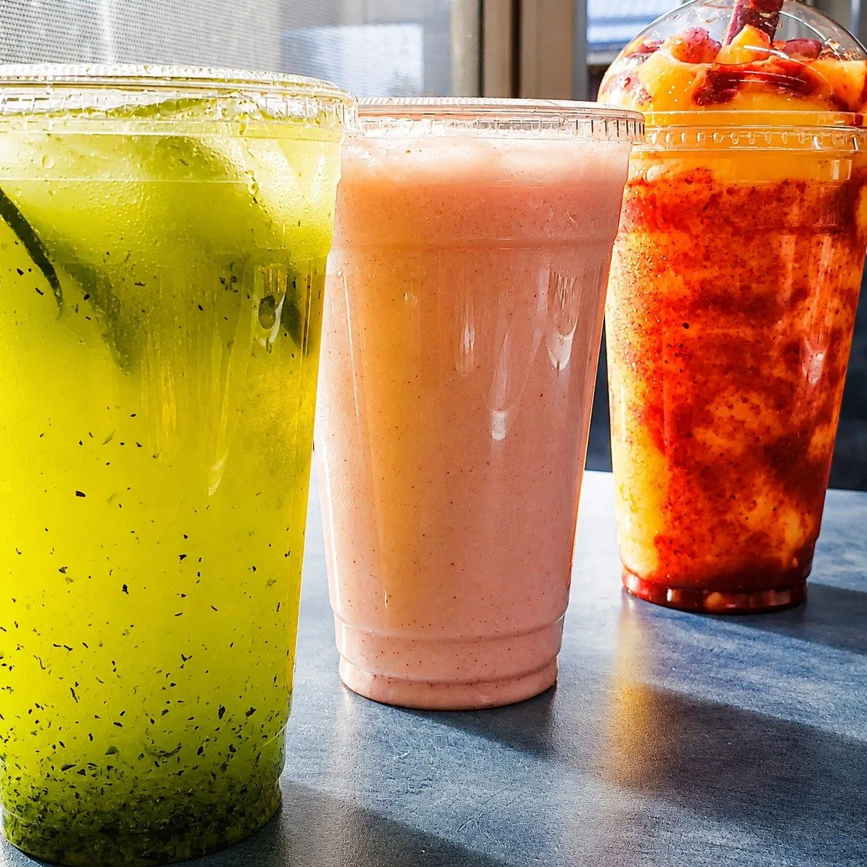 Aguas frescas in mint, strawberry, and mango-chamoy flavors
