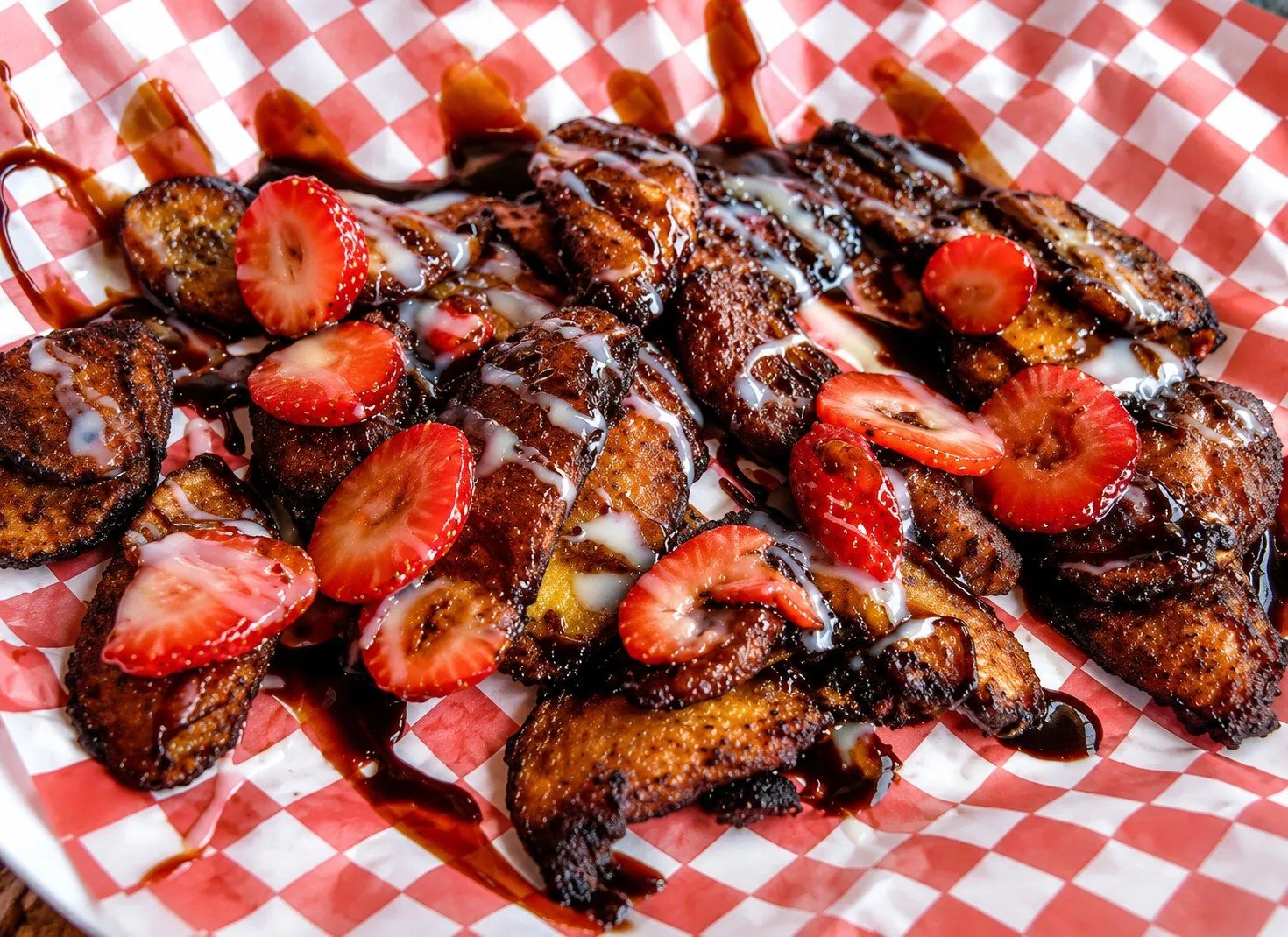 Fried plantains topped with fresh strawberries and condensed milk